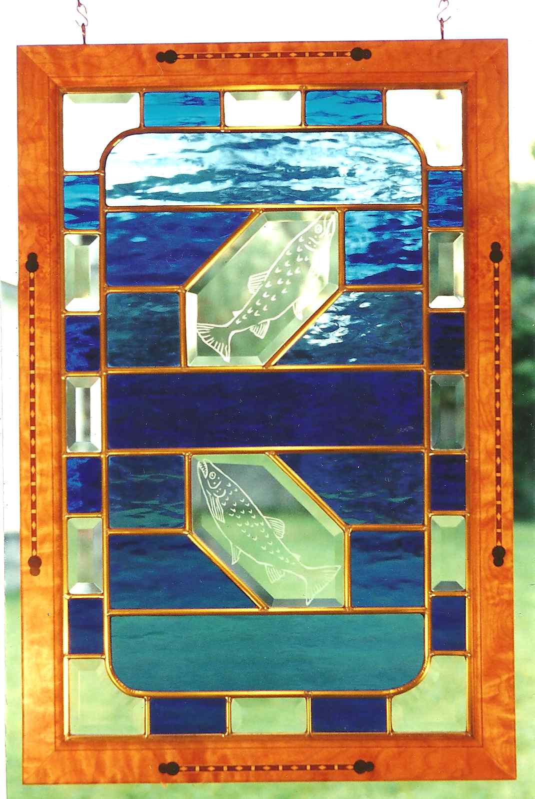 Photograph of a stained glass window featuring two salmon in it